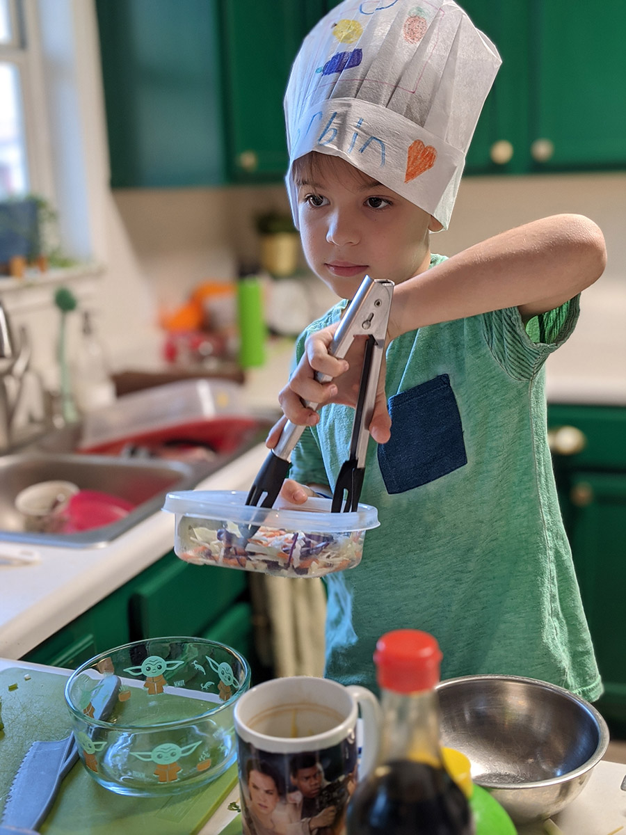 boy cooking during a sticky fingers cooking online birthday party